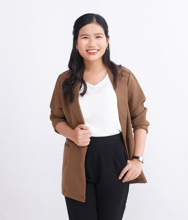 Professional woman in elegant attire with friendly demeanor